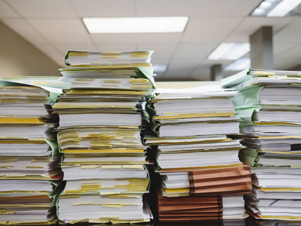 Stacks of papers on a shelf