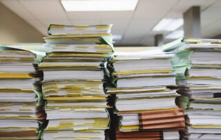 Stacks of papers on a shelf